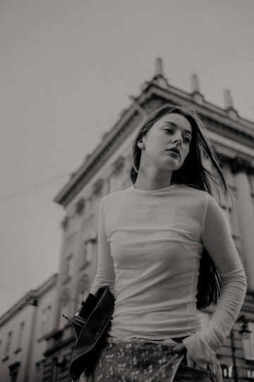 A woman walking through the city in a quiet fashion editorial moment